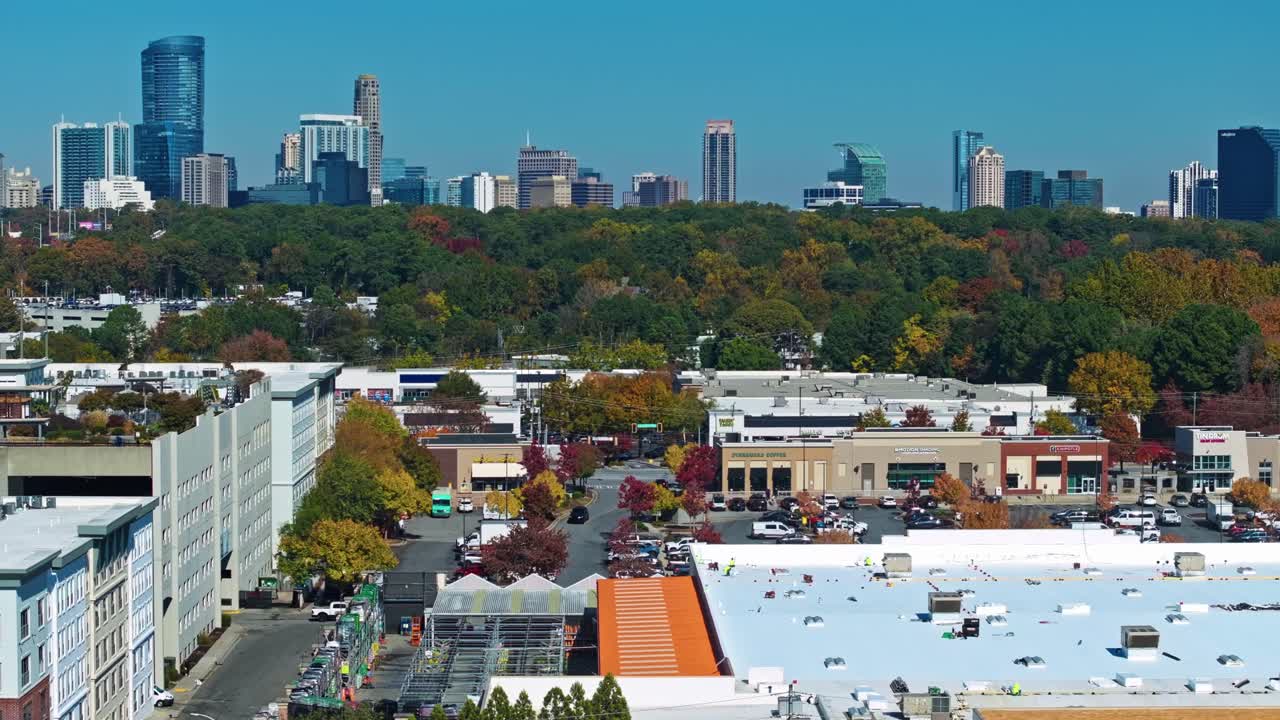 Buckhead, Atlanta, Georgia, United States of America - Colorful Autumn Trees Surround Busy Commercial Blocks as Buckhead’s Tall Skyline Rises Sharply Against the Clear Blue Sky - Static Shot