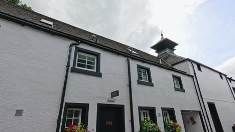 white building with flowers and cloudy sky