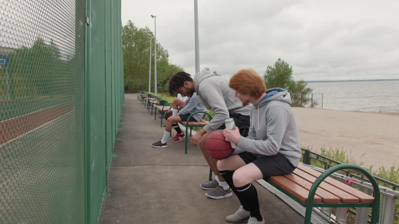 A group of friends playing basketball on an outdoor court