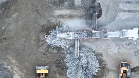 Drone-shot-of-conveyer-belt-sorting-rocks-and-rubble-into-piles-in-quarry-mine