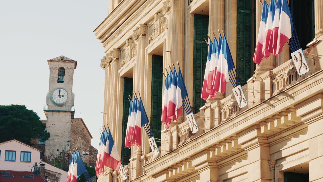 Campo lungo di un edificio storico decorato con bandiere tricolori francesi in una giornata limpida