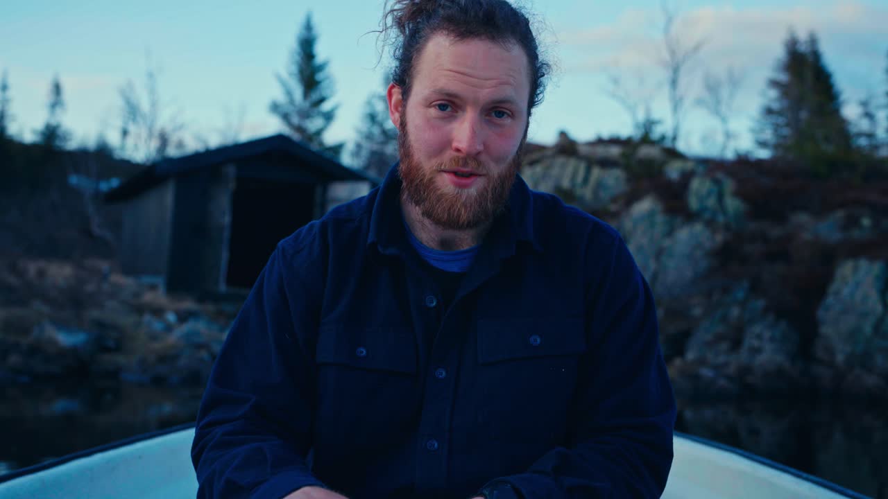 A Man Engages in Conversation While Rowing a Boat on Reinsjøen in Åfjord, Trøndelag, Norway - Close Up