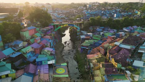 aerial-view-of-a-golden-sunset-shining-in-the-Rainbow-village-of-Malang,-East-Java,-Indonesia