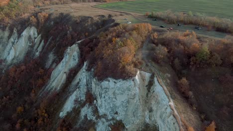 autumnal cliffside landscape with autumn colors and cars