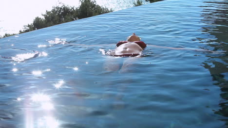 woman lying on the back in a swimming pool