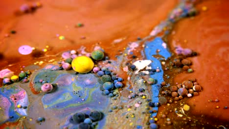 abstract colorful acrylic and food paint bubbles on water