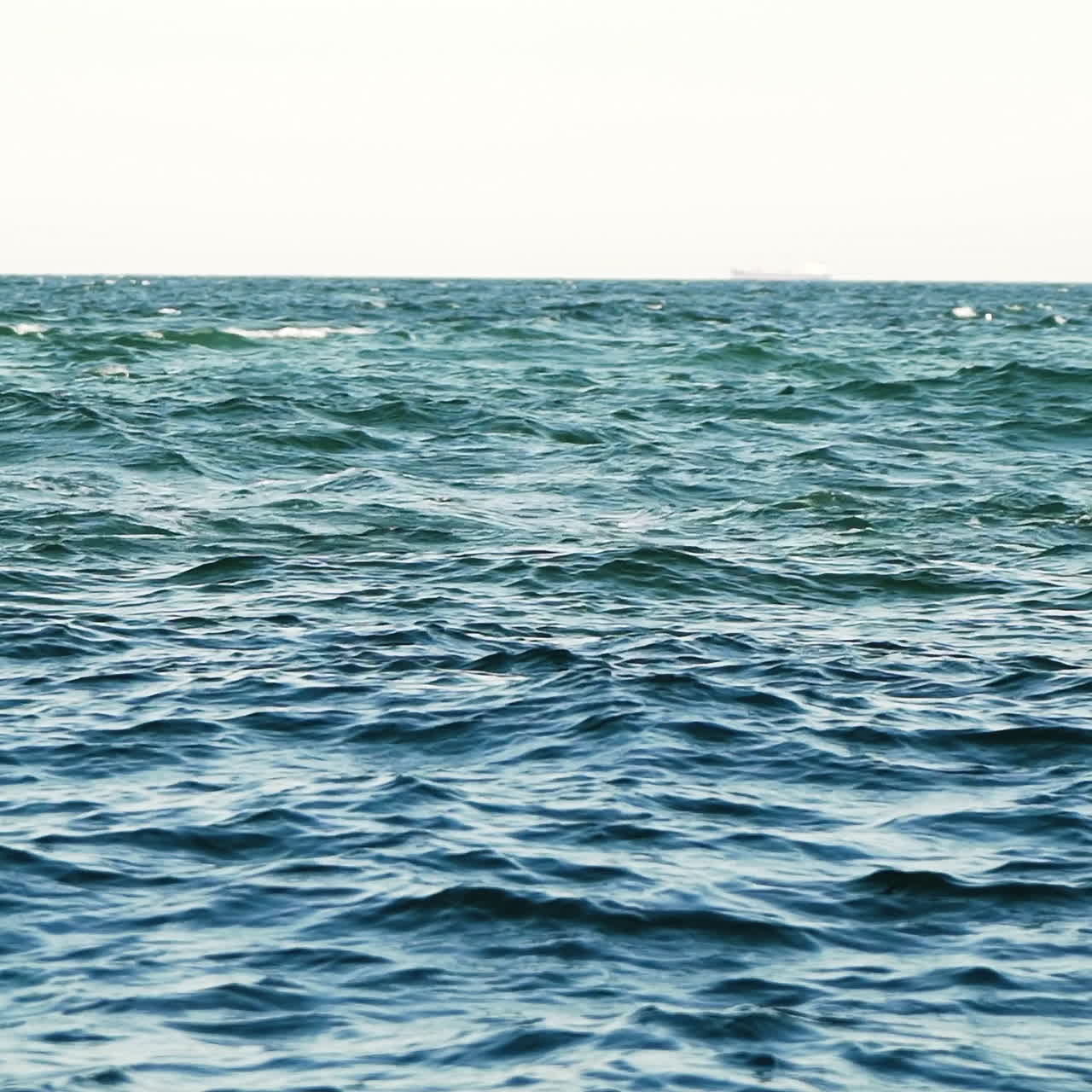 Natural background of a beautiful blue sea with slight waves. Slow ...