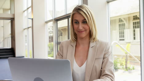 businesswoman using laptop in office 4k