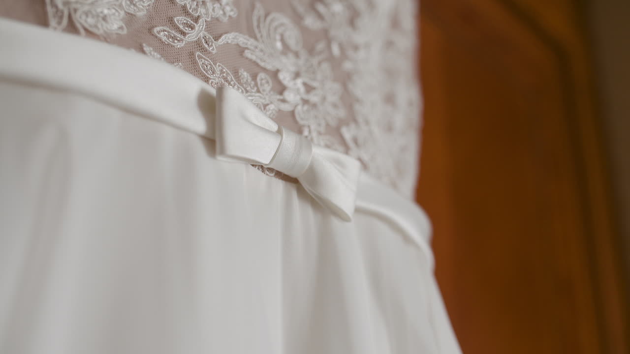 Close-up of White Wedding Dress with Lace and Bow Detail