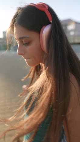 woman with headphones on a rooftop