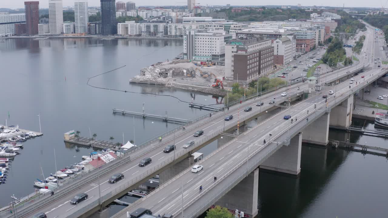 Traffic going over canal on bridge in S&ouml;dermalm, Stockholm, Sweden during cloudy evening