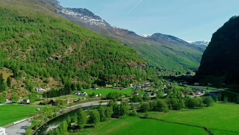 drone aerial view of an idyllic town in the middle of a green valley