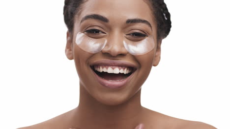 woman with eye patches smiling