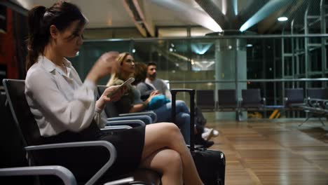 commuters using mobile phone in waiting area 4k