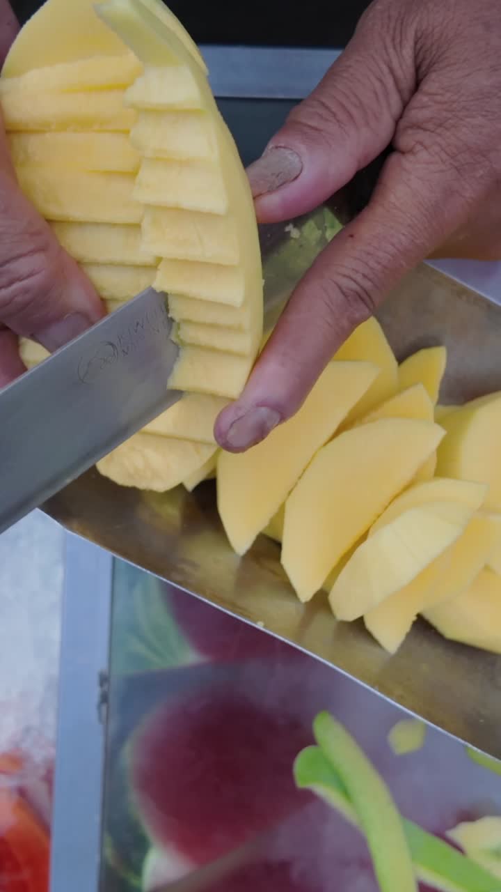 Preparing fresh mango slices