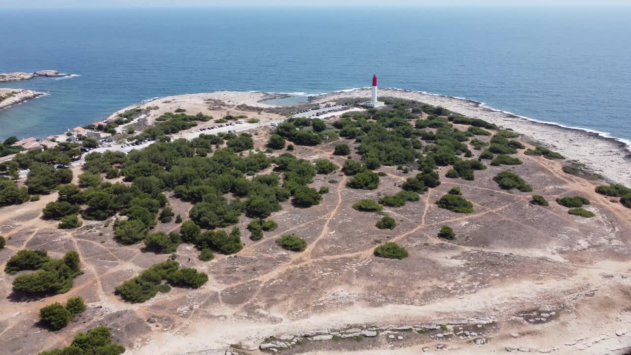 Slow cinematic 4K drone clip over a beach towards a lighthouse Phare de Cap Couronne and the Mediterranean in Martigues commune, France