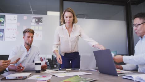 professional businesswoman giving document papers to her colleagues in modern office in slow motion