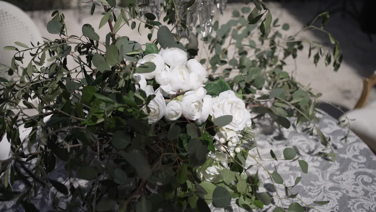 Elegant white flower bouquet on a lace tablecloth, perfect for a sophisticated wedding decor