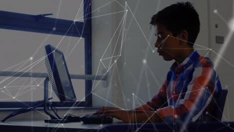 network of connections against boy using computer at elementary school