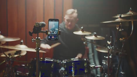 drummer recording a drumming session with a smartphone