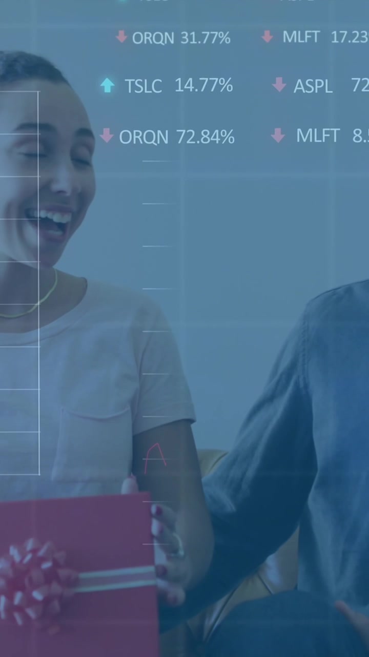 Animation of graphs and trading boards, diverse man surprising woman by presenting gift at home