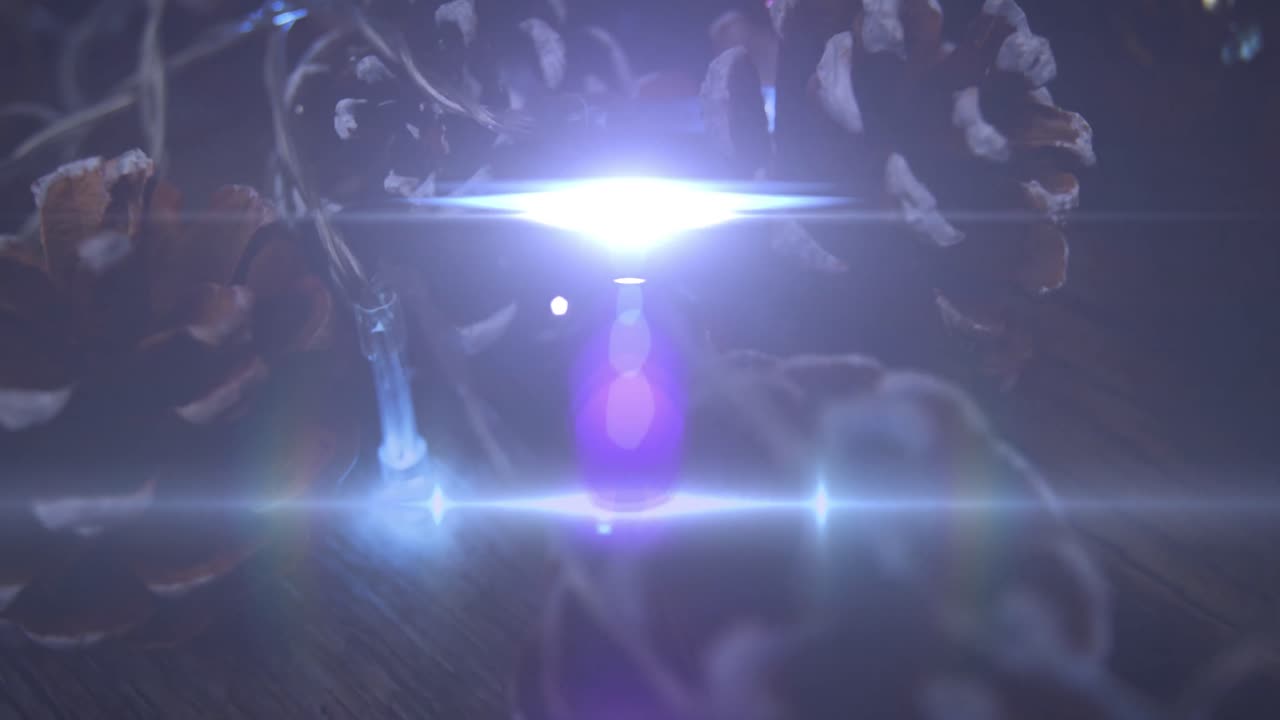 Animation of glowing lights moving over fir tree cones christmas decorations