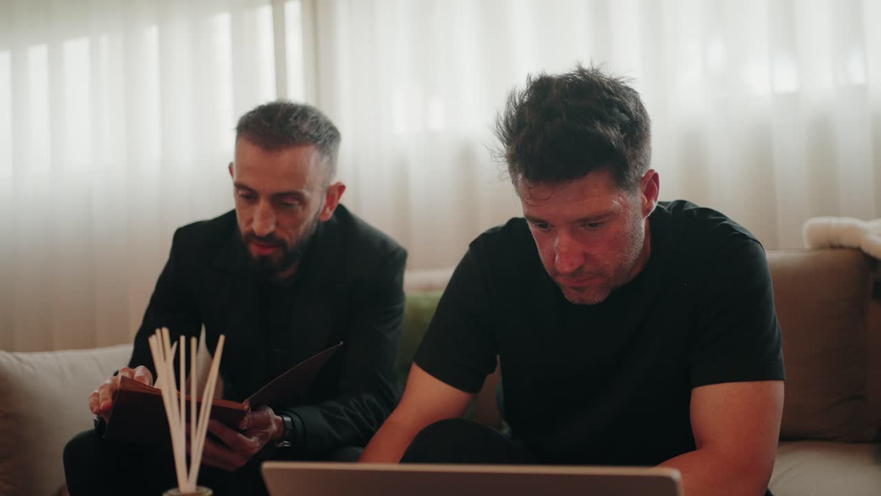 quiet focused moment shared between two men in a softly lit room