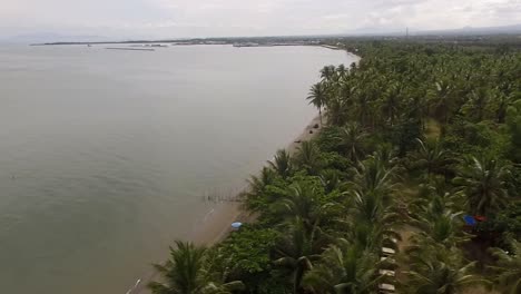 empty sandy beach and beautiful calm sea on cloudy day, drone aerial