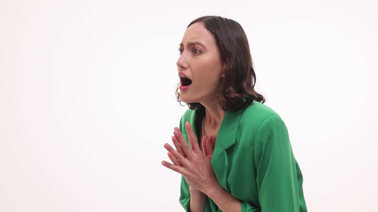 Woman reacting with shock and surprise on a white background