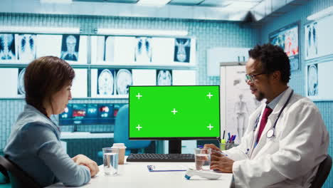 general practitioner consulting a female patient next to isolated chroma key