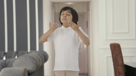 Happy-Indian-boy-doing-breathe-in-breathe-out-exercise