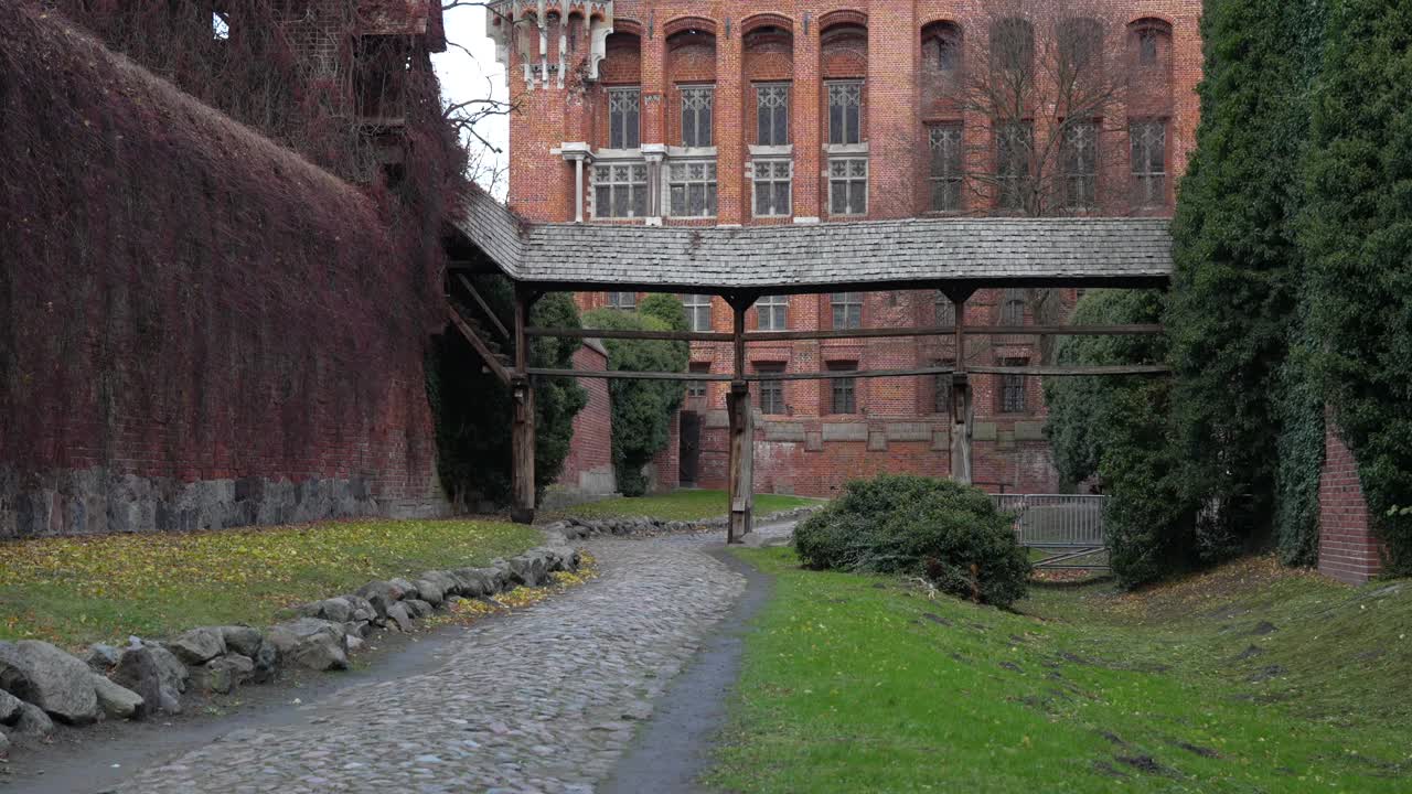 Cobblestone path around world's largest castle. Malbork fortress, famous landmark in Poland