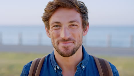 happy backpack man, face and smile in park by sea