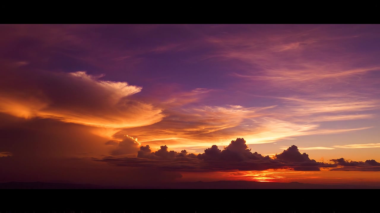 Dramatic purple and orange sunset sky with cinematic clouds