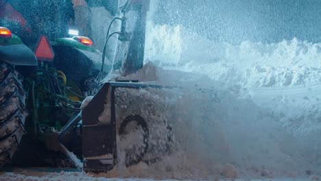 Snow-plow-blower-truck-cleaning-thick-snow-after-blizzard-storm-from-road-at-night