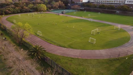 women playing soccer at sunset. aerial view