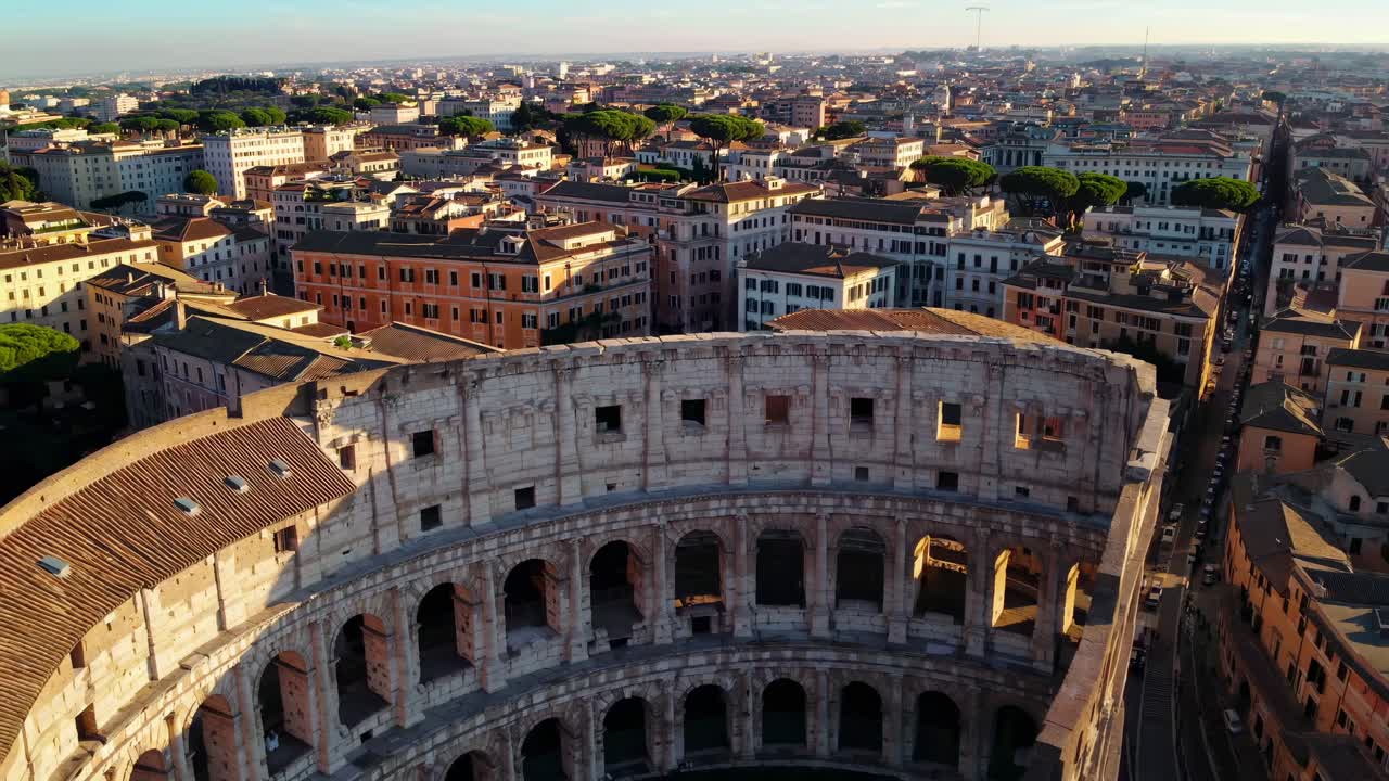Aerial video view of the Colosseum in Rome at sunrise, showcasing the ancient architecture
