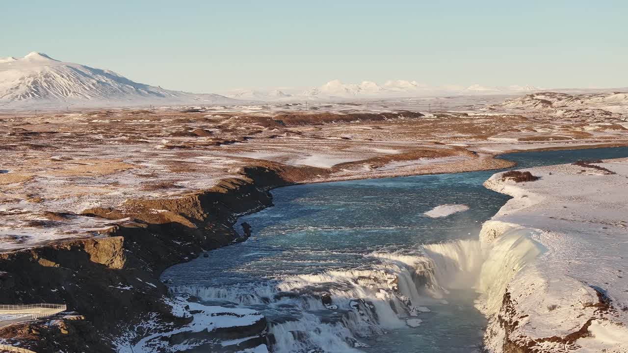 Aerial shot of Gullfoss waterfall in Iceland, with Hvítá river and snowy landscape