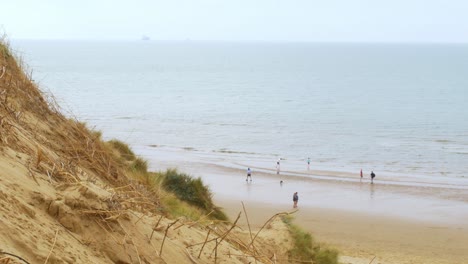 Formby-beach,-Merseyside-coastline-beach-a-ship-sails-on-the-horizon