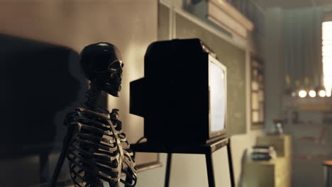 a skeleton watching tv in an empty classroom