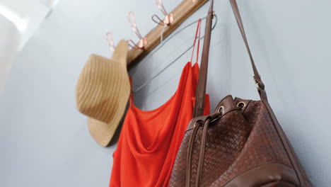 Hat,-dress-and-purse-hanging-on-hook-4k