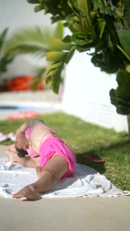 child doing yoga by the pool