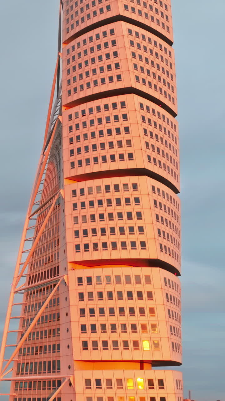 Aerial drone view of Turning Torso residential skyscraper in Malmo, Sweden at sunset. Vertical
