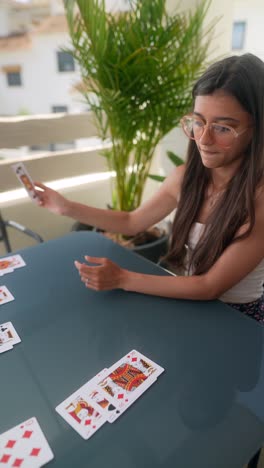 woman playing cards on a patio