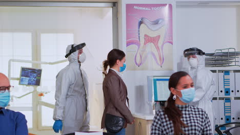 personas con máscara de protección sentadas en la zona de espera