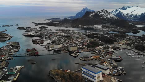 cinematic aerial of a small scandinavian island town with mountains