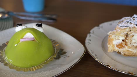 a budapest and princess frog cake dessert on a table in a restaurant in sweden