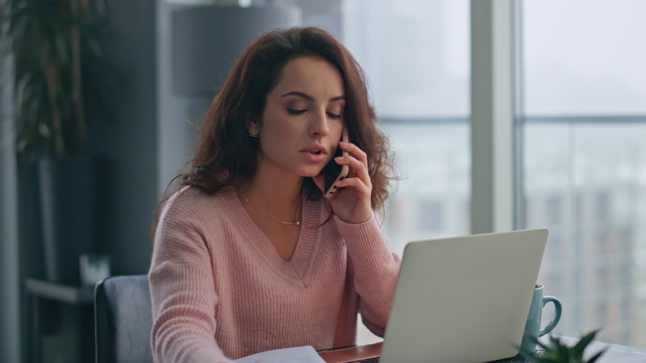 Financial manager talking smartphone at home desk closeup. Businesswoman working