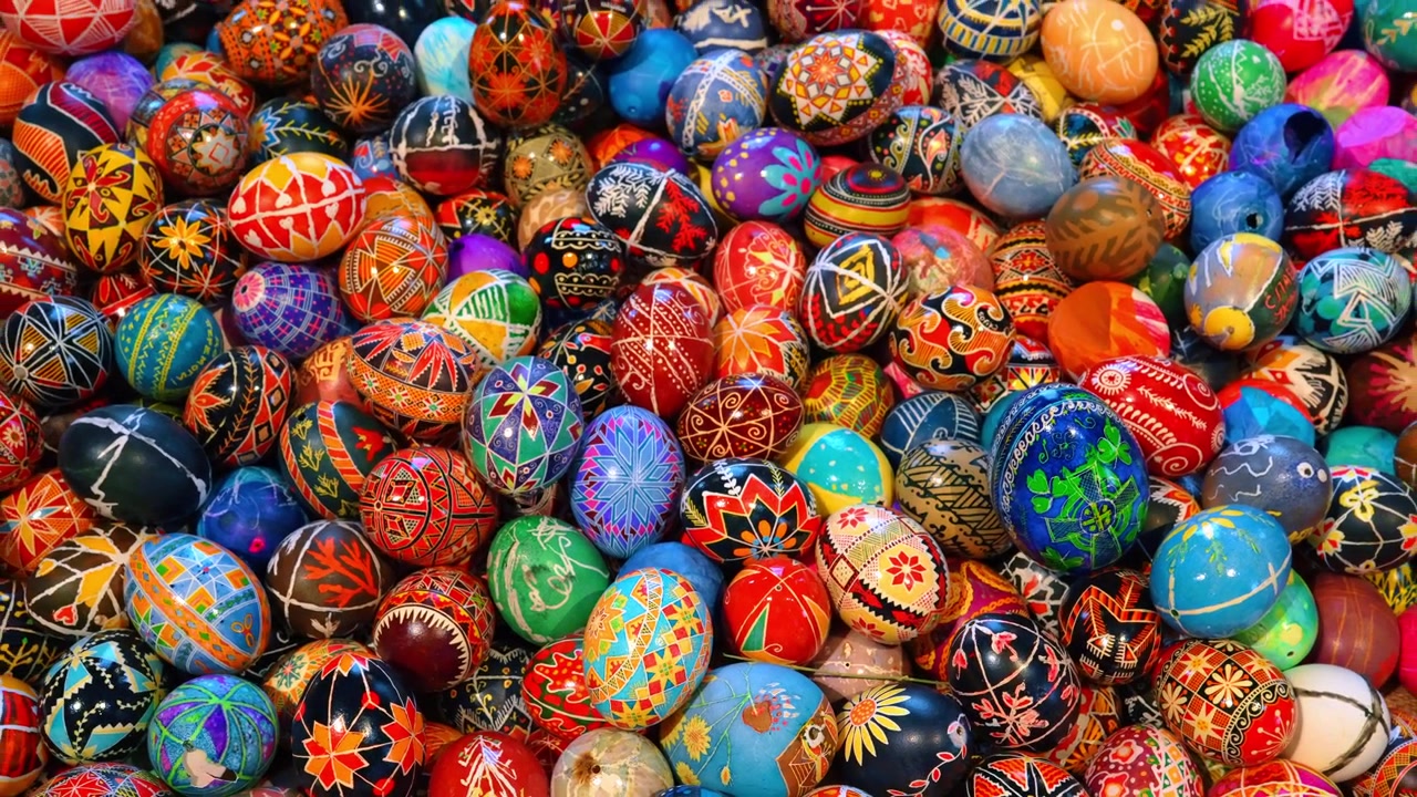 Many traditional Ukrainian Pysanky eggs with geometric patterns. High angle view of a pile of colorful hand-decorated Pysanky eggs with diverse traditional designs in New York City.