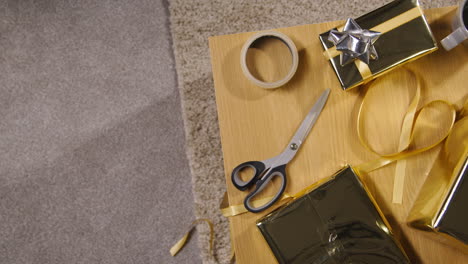 overhead shot of gift or present being wrapped on table at home 1